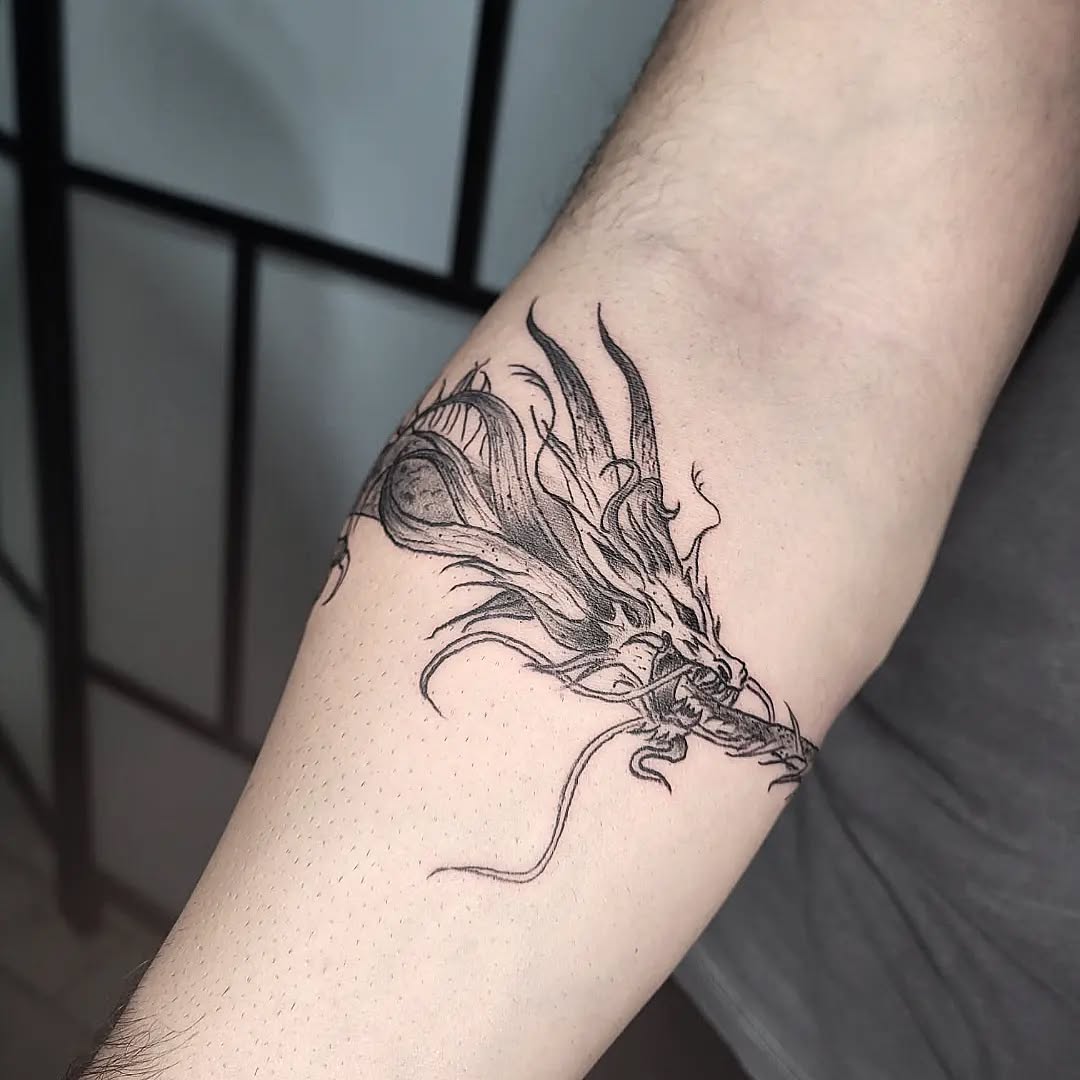 Blackwork dragon arm tattoo in Lisbon